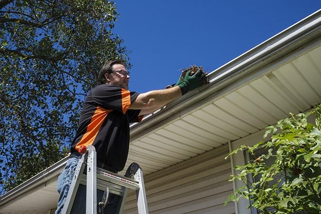 dirty gutter being unclogged and repaired in Cooper City